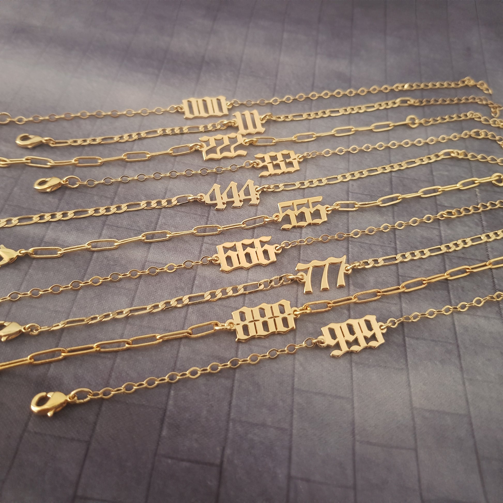 a bunch of gold chains with numbers on them