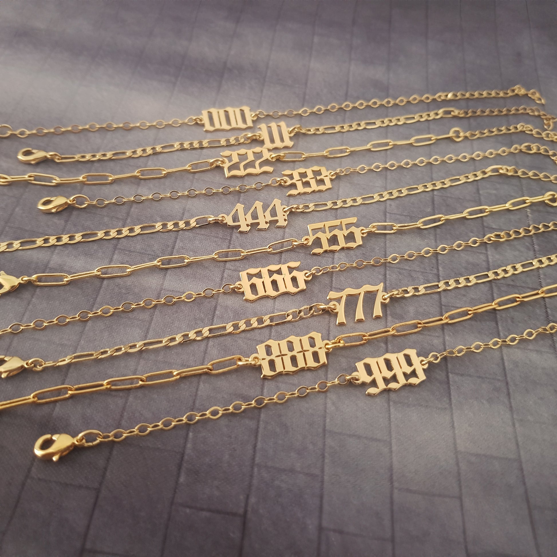 a bunch of gold chains with numbers on them