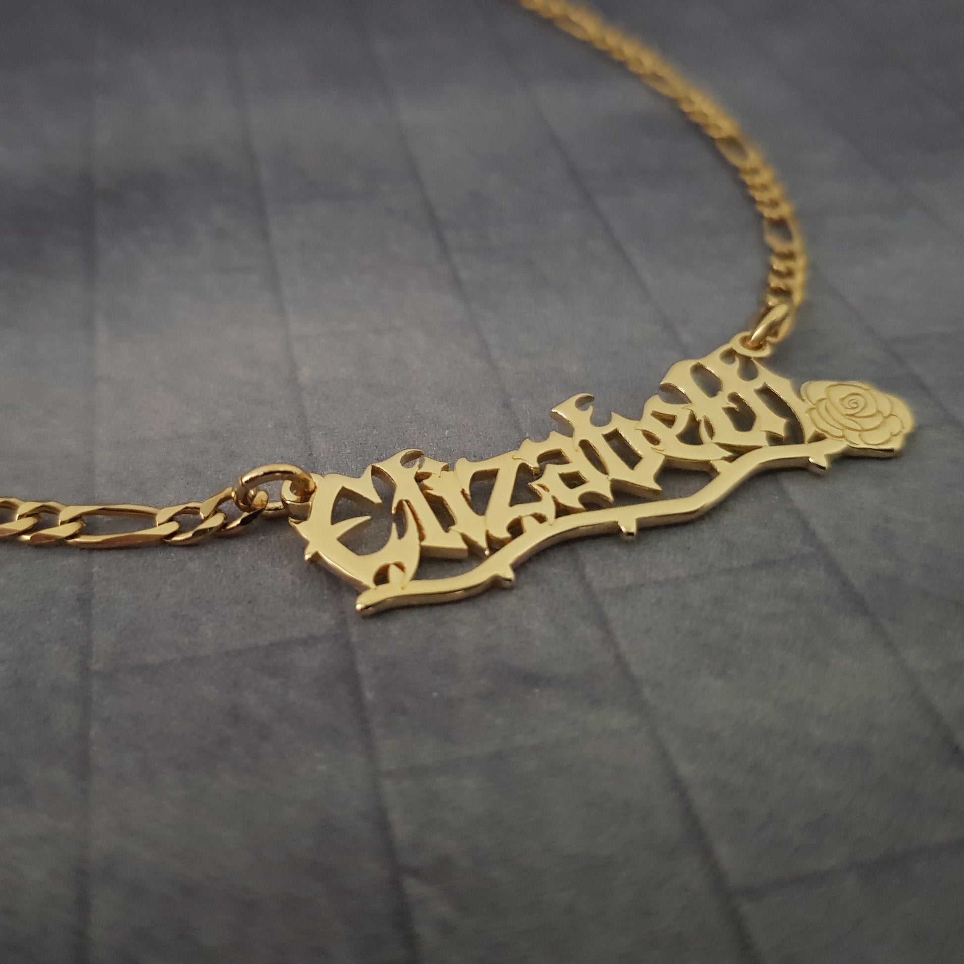 a gold necklace with a name on it