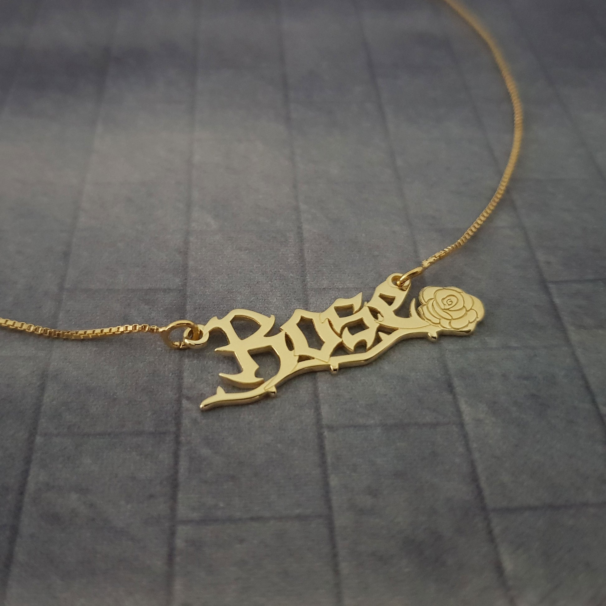 a gold necklace with the word hope on it