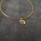 a gold necklace with the letter m on it