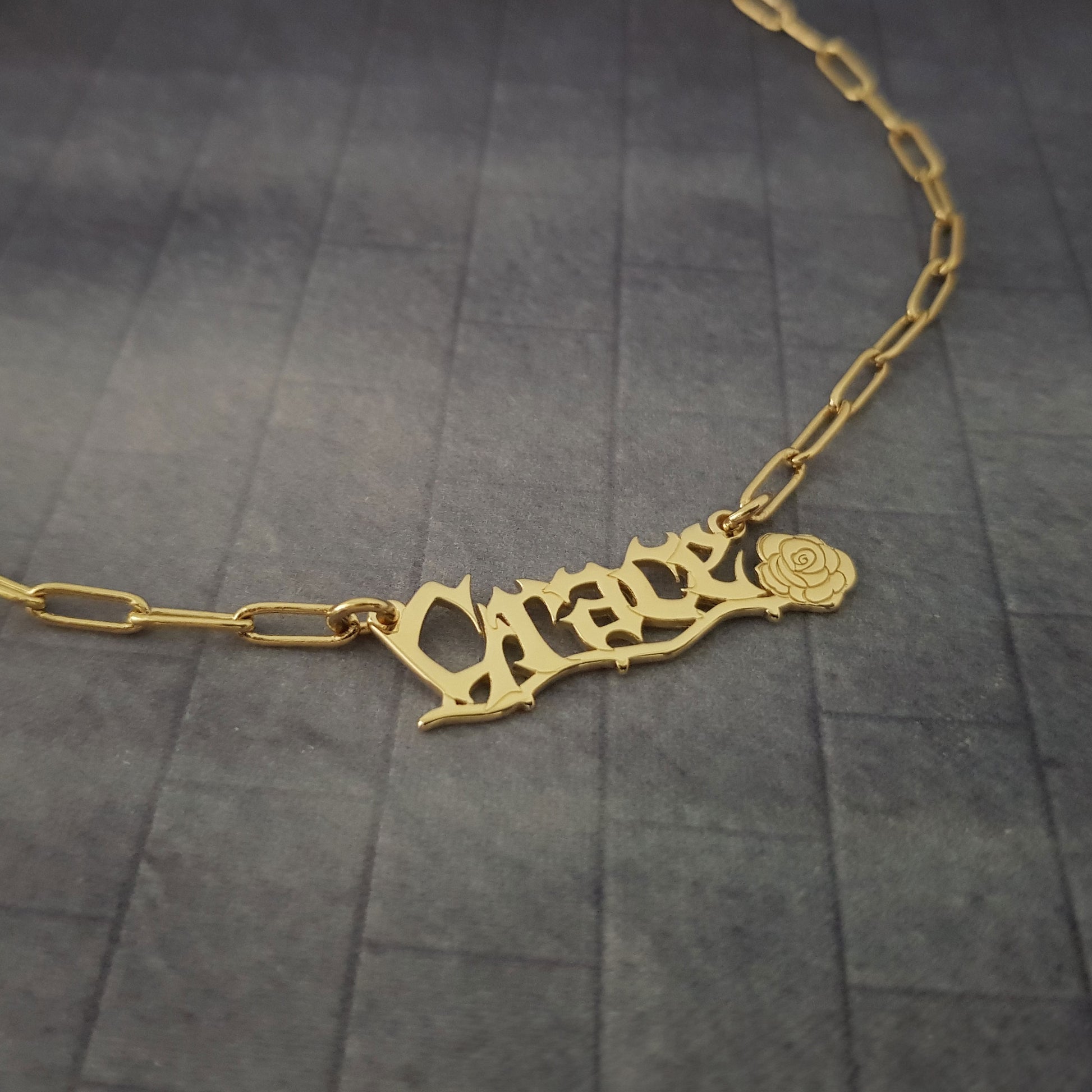 a gold necklace with a name on it