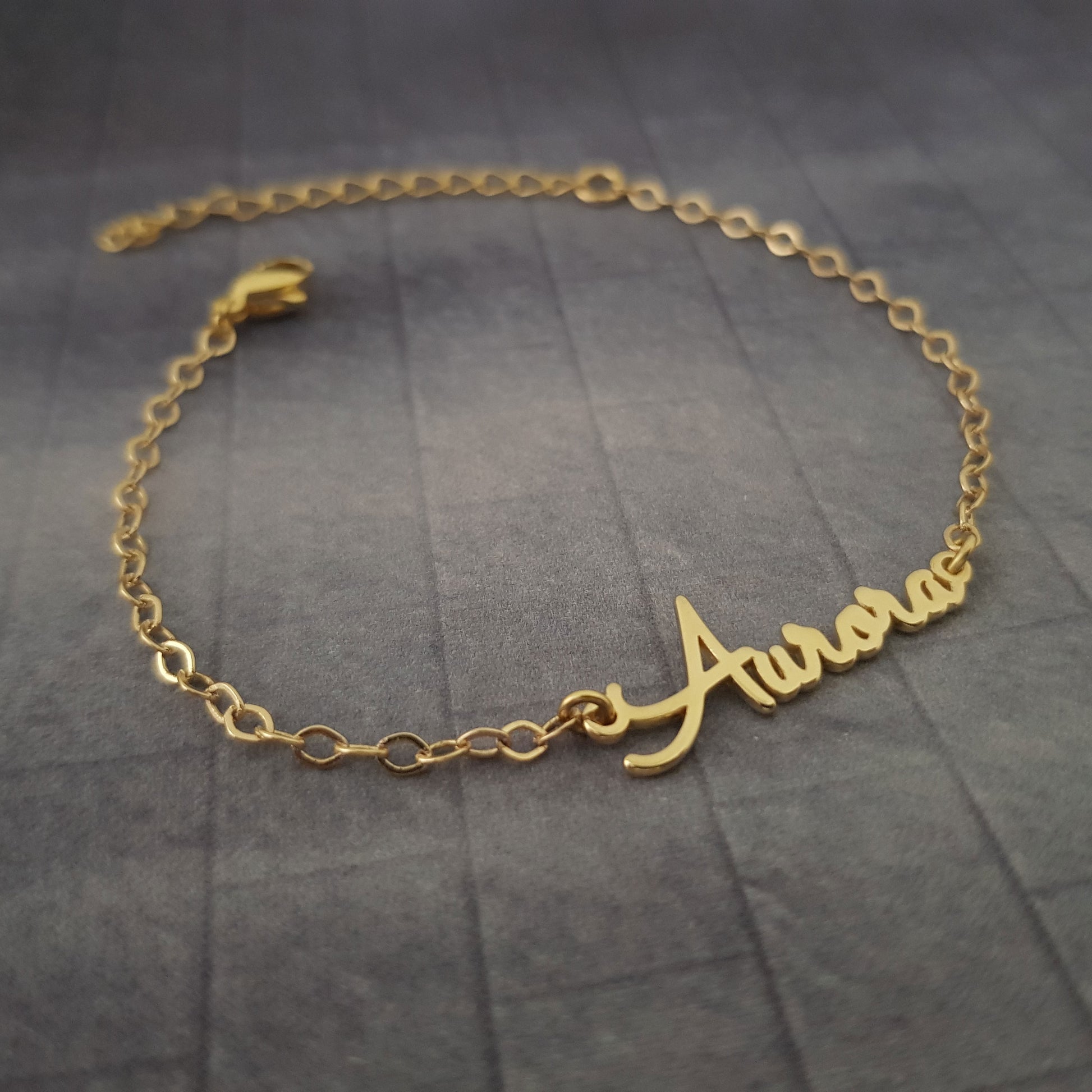 a gold bracelet with the word always on it