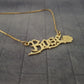 a gold necklace with a rose on it