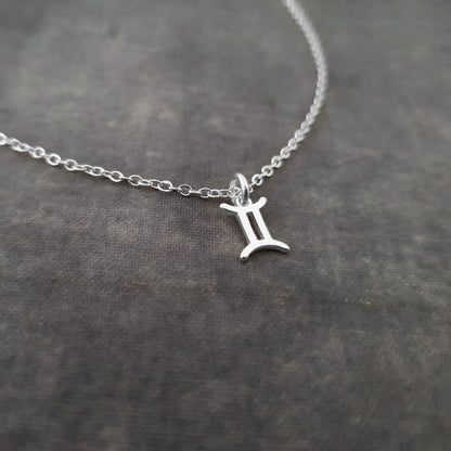 a silver necklace with a letter on it