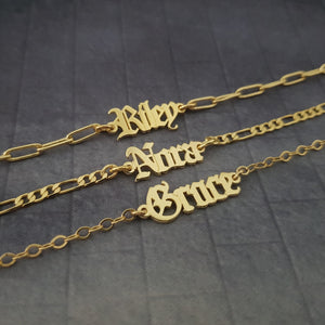 three personalized name necklaces on a table