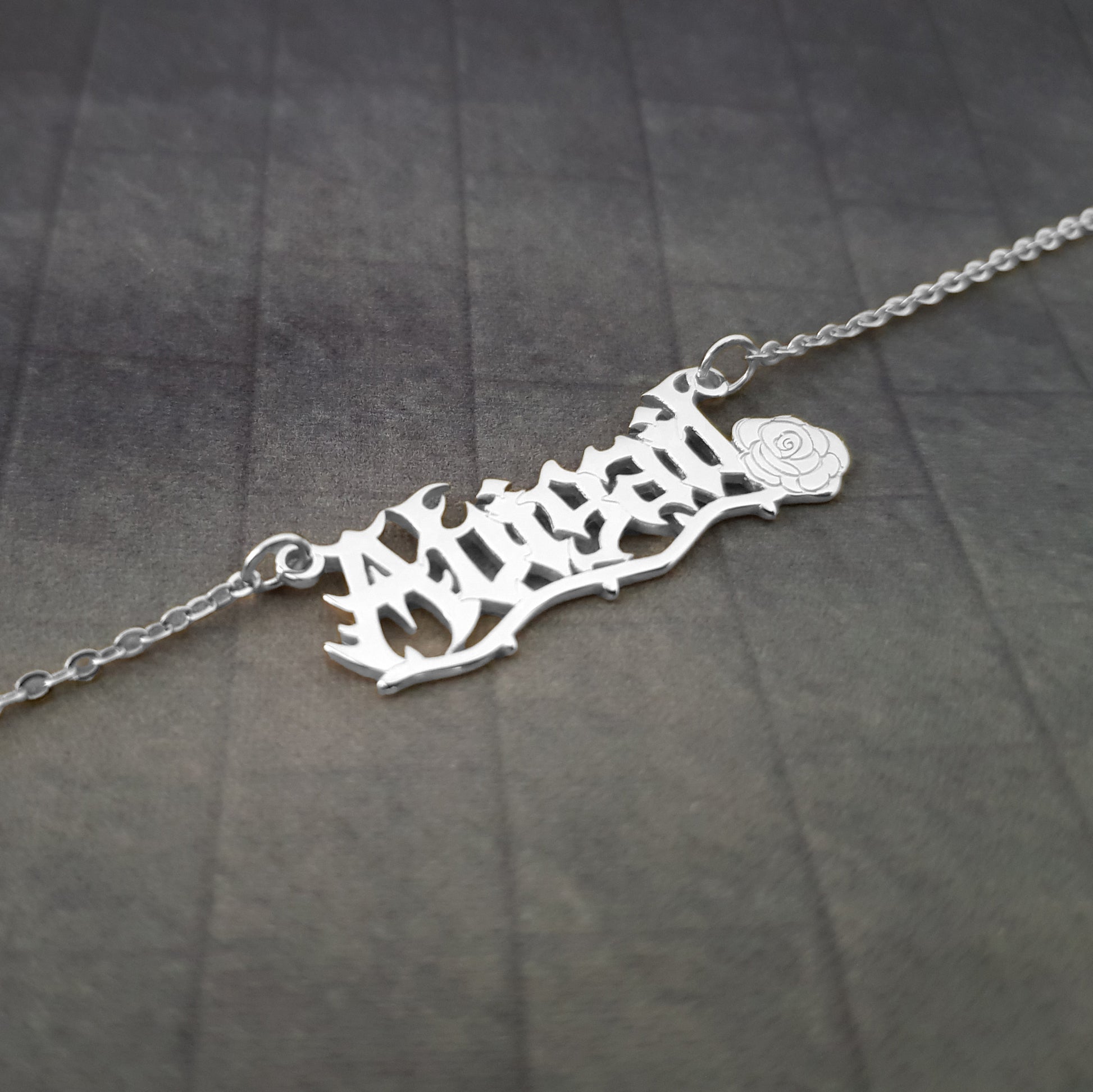 a silver necklace with a name on it