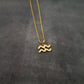 a gold necklace with a zodiac sign on it