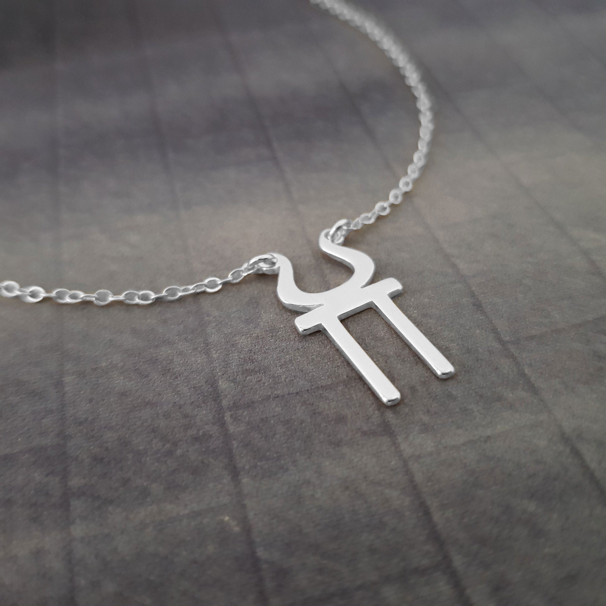 a silver necklace with a cross on it