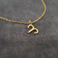 a gold necklace with the letter s on it