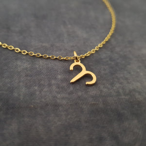 a gold necklace with the letter s on it