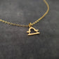 a gold necklace with a heart on it