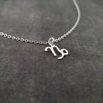 a silver necklace with the letter m on it