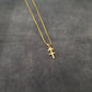 a gold necklace with a cross on it