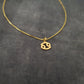 a gold plated necklace with the letter s on it