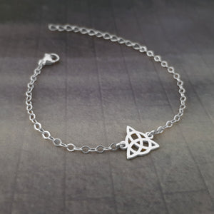 a silver bracelet with a celtic knot on it