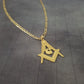 a gold necklace with an eye and a triangle