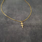 a gold necklace with a cross on it