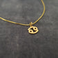 a gold necklace with a smiley face on it