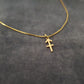 a gold necklace with a cross on it