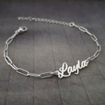 a silver chain bracelet with a name on it