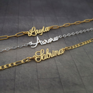 three personalized name necklaces on a table