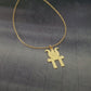 a gold necklace with a bird on it