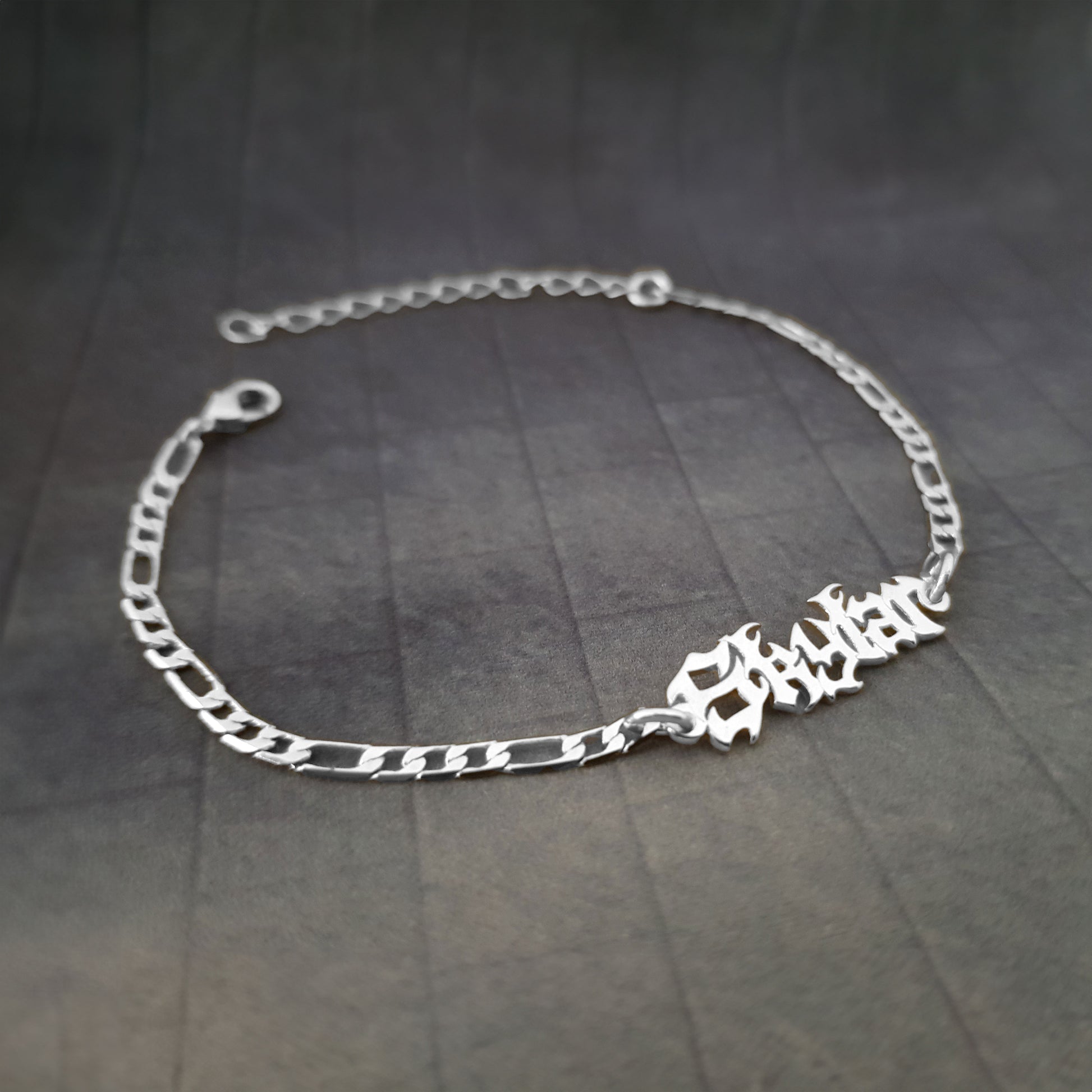 a silver bracelet with a name on it