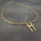 a gold necklace with a cross on it