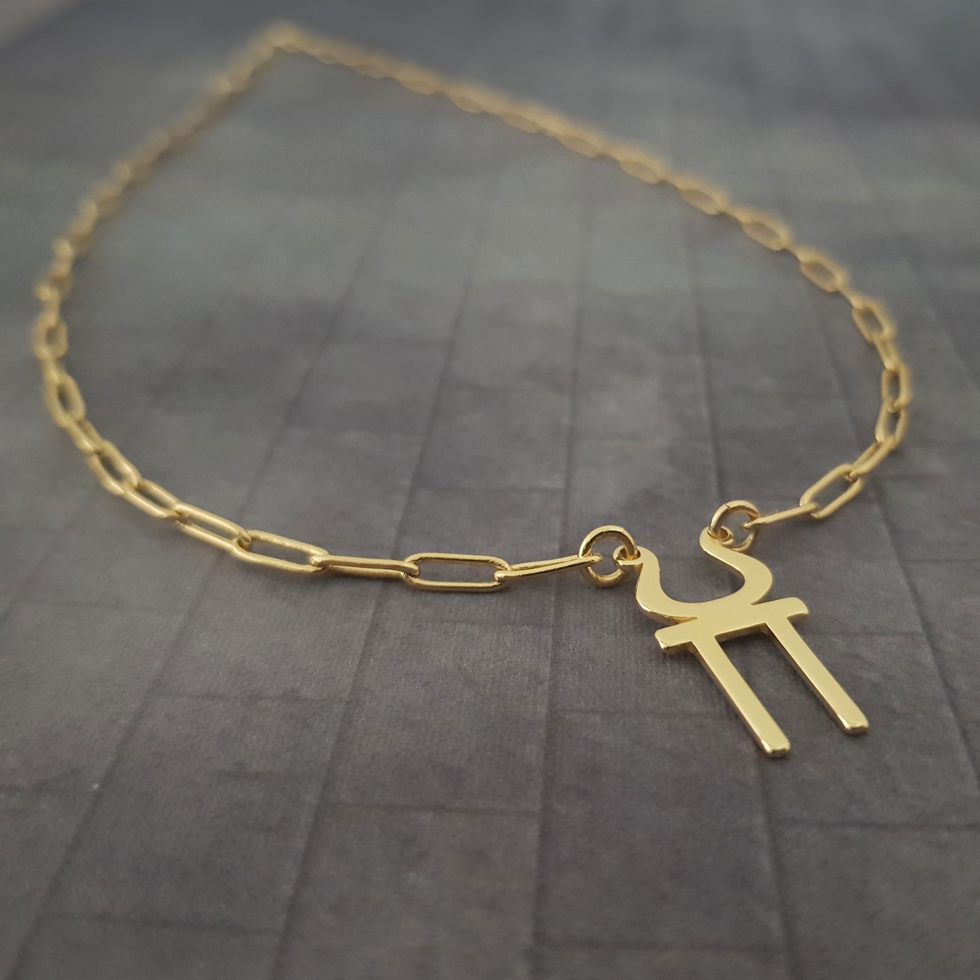 a gold necklace with a cross on it