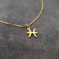 a gold necklace with a cross on it