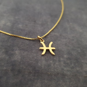 a gold necklace with a cross on it