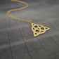a gold necklace with a triangle on it