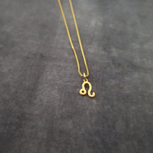 a gold necklace with the letter o on it