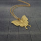 a gold necklace with a butterfly on it