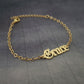 a gold bracelet with the word love on it