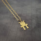 a gold necklace with a bird on it