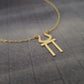 a gold necklace with a cross on it