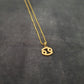 a gold necklace with a smiley face on it