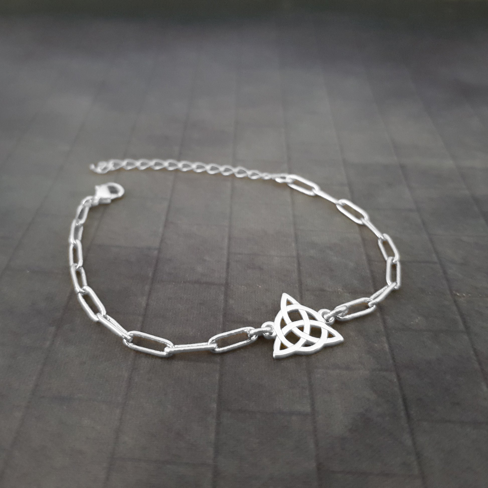 a silver bracelet with a star on it