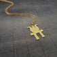 a gold necklace with a bird on it