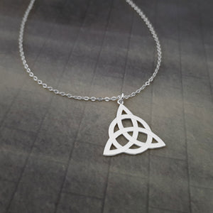 a silver necklace with a celtic knot on it