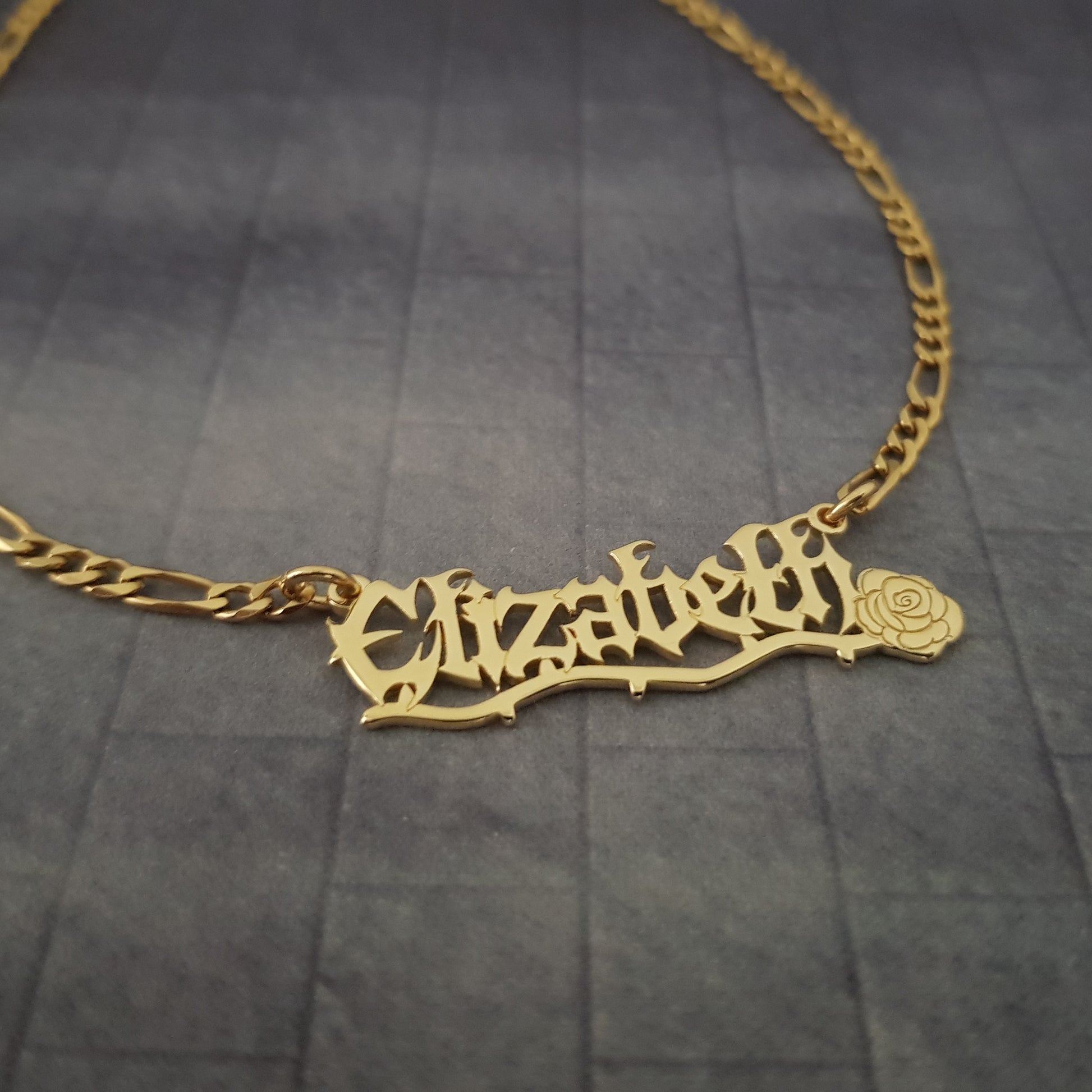 a gold necklace with a name on it