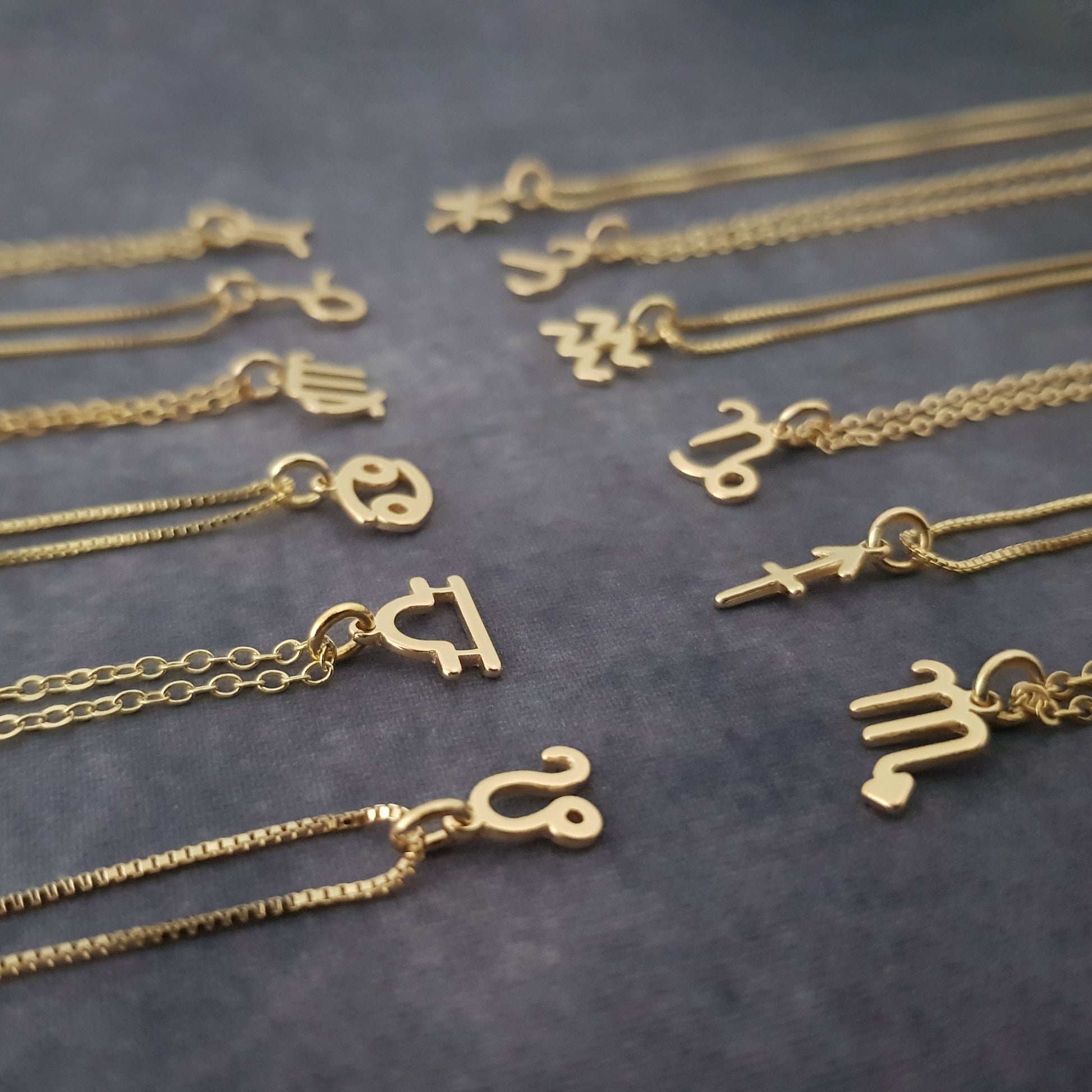 a bunch of gold necklaces sitting on top of a table